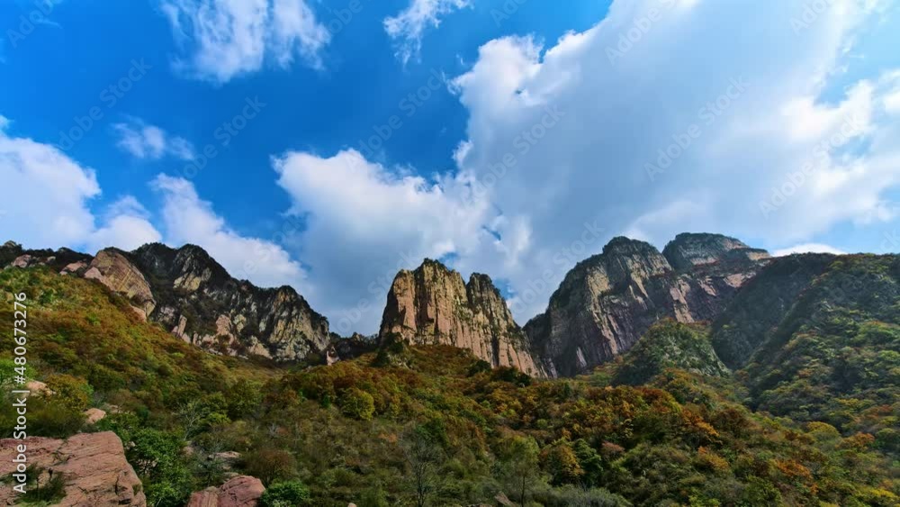 Low angle shot of time-lapse of clouds flowing over the peak of the mountains and the shadows on the mountains Low angle shot of time-lapse of clouds flowing over the peak of the mountains and the shadows on the mountains