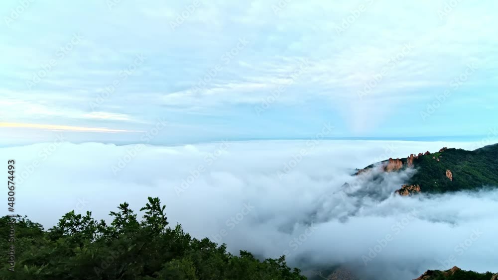 Time-lapse of the sea of clouds on the top of the mountains formed by the flowing clouds in the sky Time-lapse of the sea of clouds on the top of the mountains formed by the flowing clouds in the sky