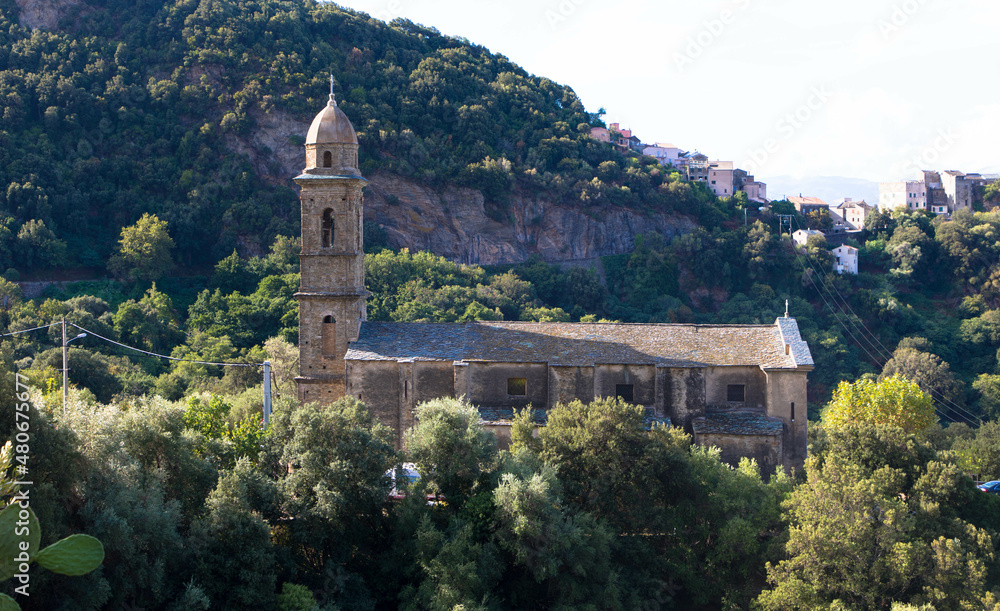Beautiful view of the 16th century Church of Saint Martin in Patrimonio, a little town of Haute Corse with mountains in the Background, Corsica France