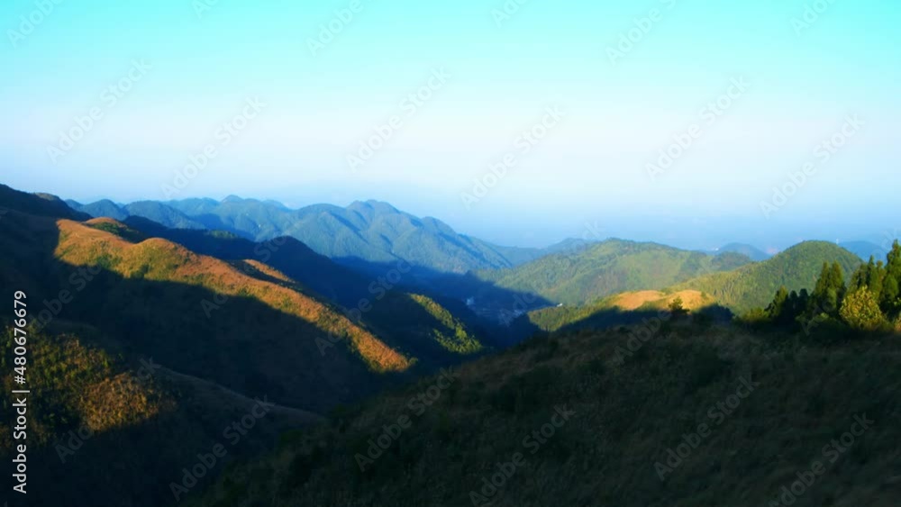 Time-lapse of light and shadows flowing on the top of the mountains under the clear sky Time-lapse of light and shadows flowing on the top of the mountains under the clear sky