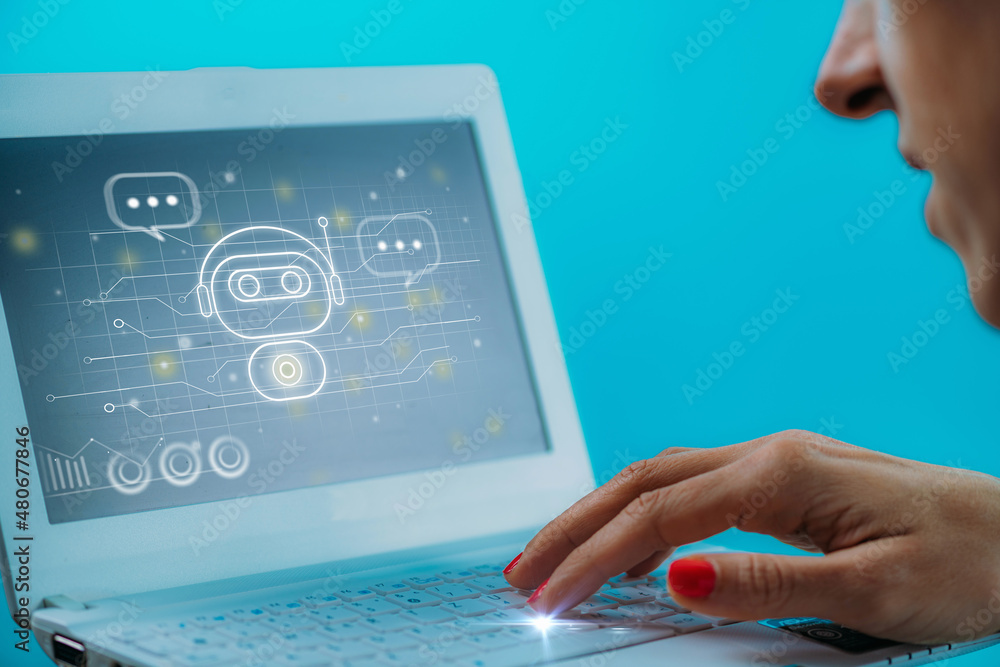 Female hand engaged in a chatting conversation with an automated digital chatbot. Female hand engaged in a chatting conversation with an automated digital chatbot.
