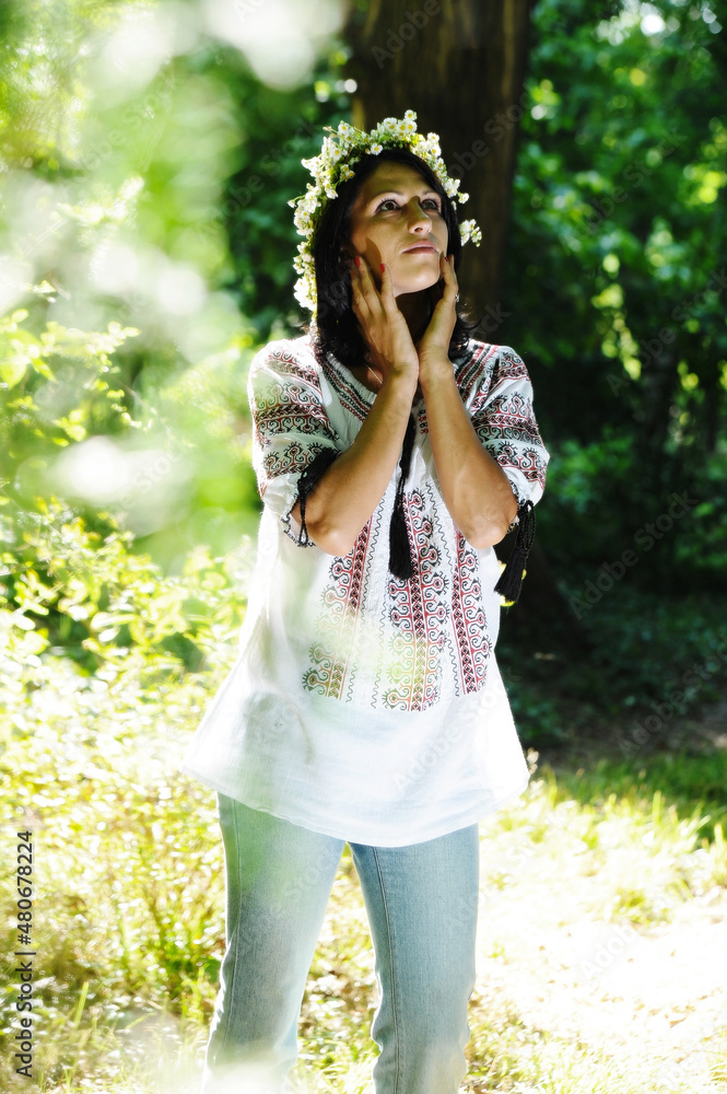 young woman picking wildflowers to make a wreath. young woman picking wildflowers to make a wreath.