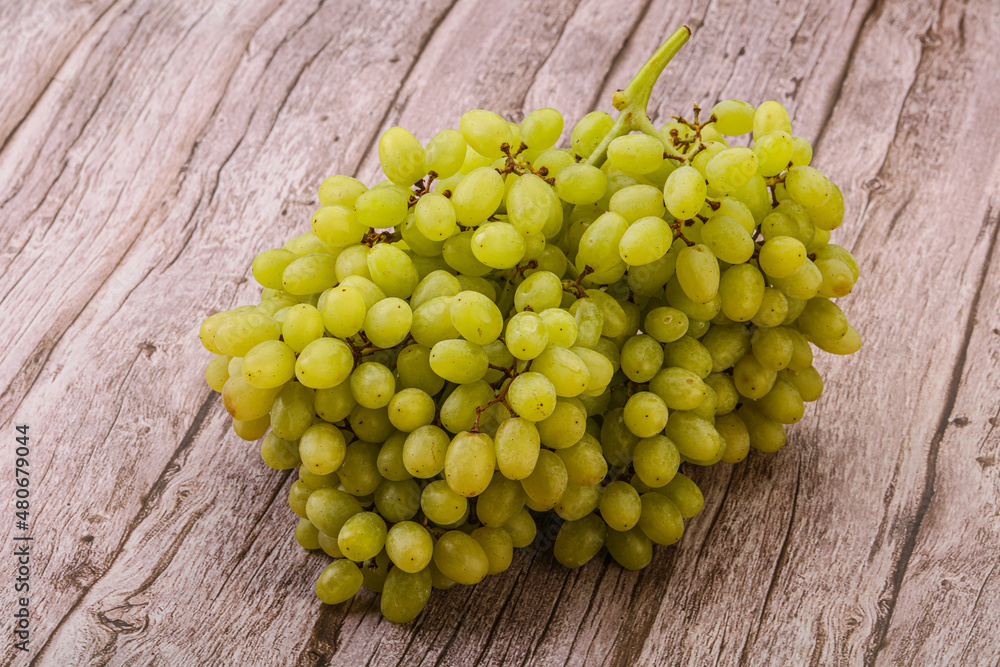 Green grape branch over background Green grape branch over background