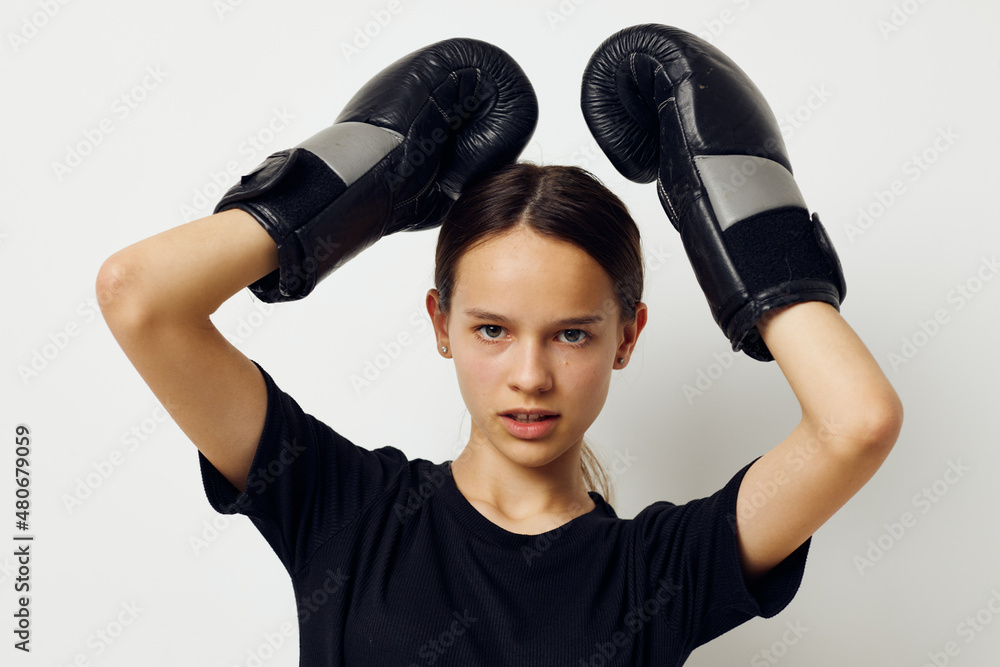beautiful girl in black sports uniform boxing gloves posing Lifestyle unaltered beautiful girl in black sports uniform boxing gloves posing Lifestyle unaltered
