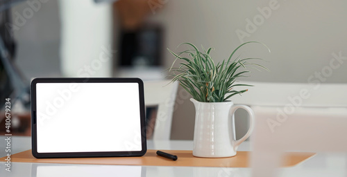 Mockup blank white screen ditital tablet on wooden table in living room  home office concept.