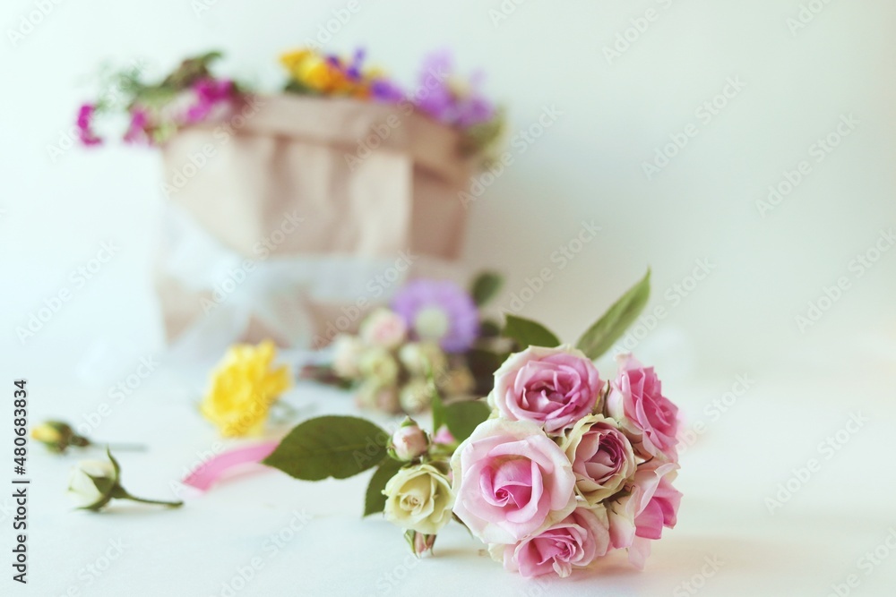 Bouquet of fresh roses, flowers on a light background, the concept of a romantic greeting, invitation, wedding, postcard, Valentine's Day or sale in a flower shop Bouquet of fresh roses, flowers on a light background, the concept of a romantic greeting, invitation, wedding, postcard, Valentine's Day or sale in a flower shop