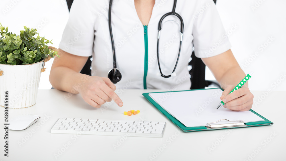 Doctor, nurse at her desk with documents and pointing out pills. Doctor, nurse at her desk with documents and pointing out pills.