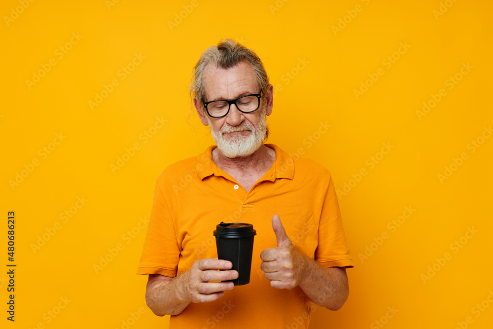 old man in a yellow T-shirt a glass with a drink monochrome shot old man in a yellow T-shirt a glass with a drink monochrome shot
