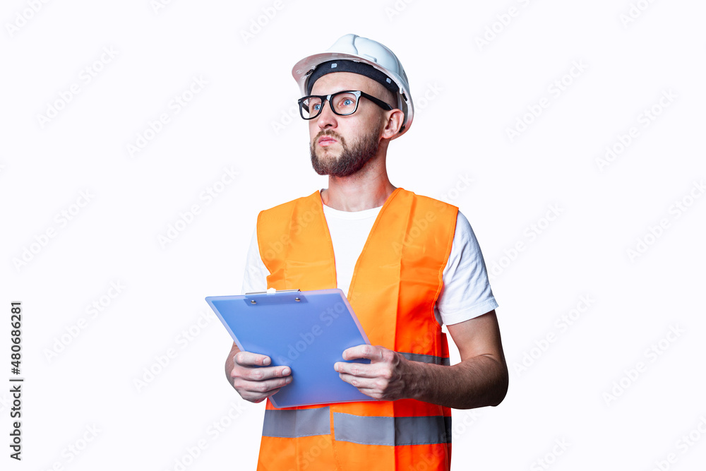 Young man in building clothes, holding a clipboard on a light background.