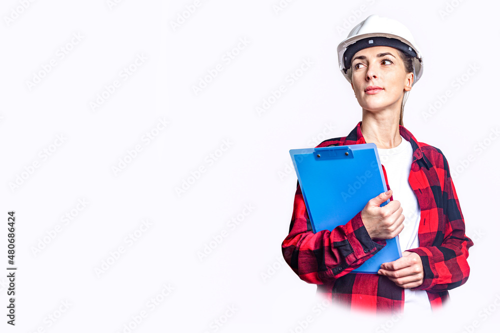 Young woman in construction clothes with clipboard on light background. Young woman in construction clothes with clipboard on light background.