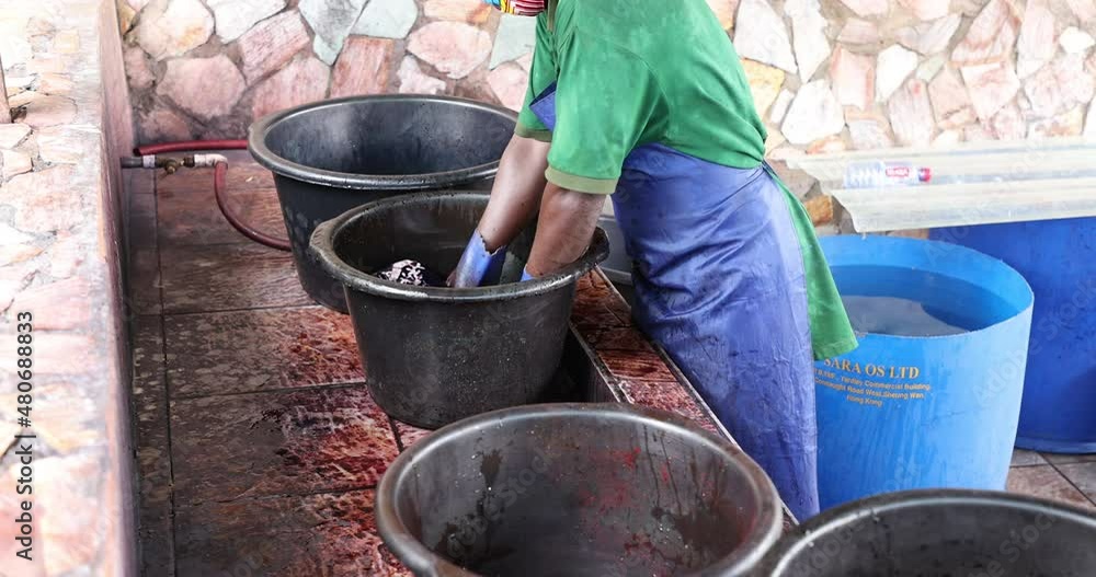 Vidéo Stock Batik fabric dye vats Accra Ghana. Local neighborhood