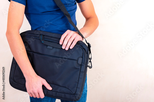 laptop bag in hand, guy holds a laptop bag in his hands