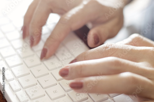 hands typing on a keyboard