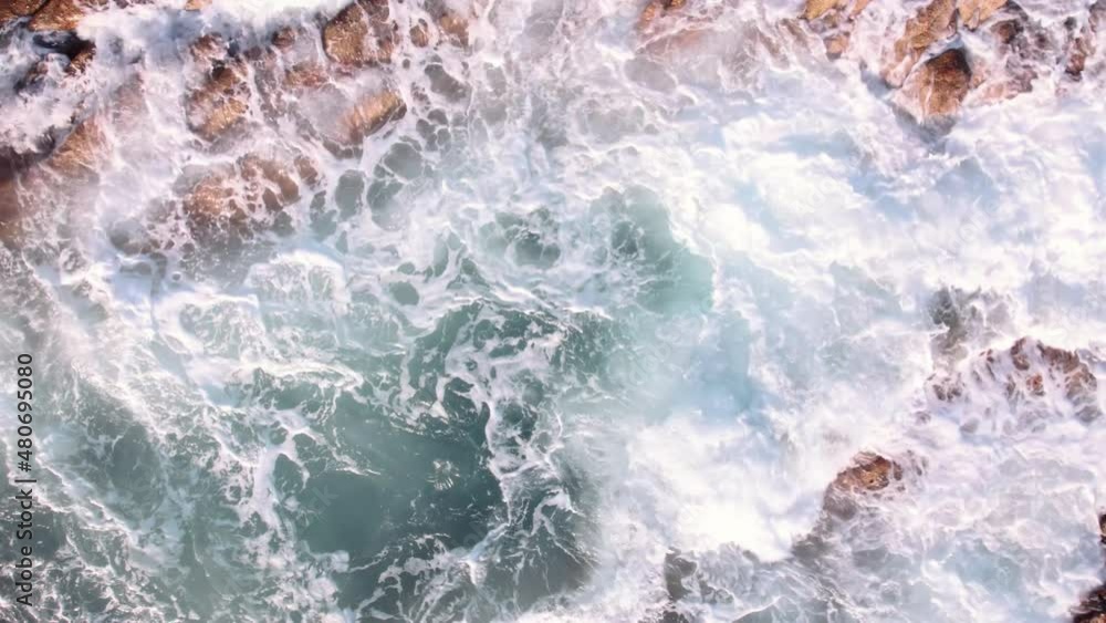 Aerial view of ocean waves breaks on the rocks. Aerial view of ocean waves breaks on the rocks.