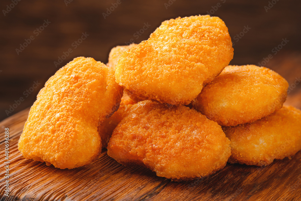 Homemade chicken nuggets on a cutting board close-up Homemade chicken nuggets on a cutting board close-up