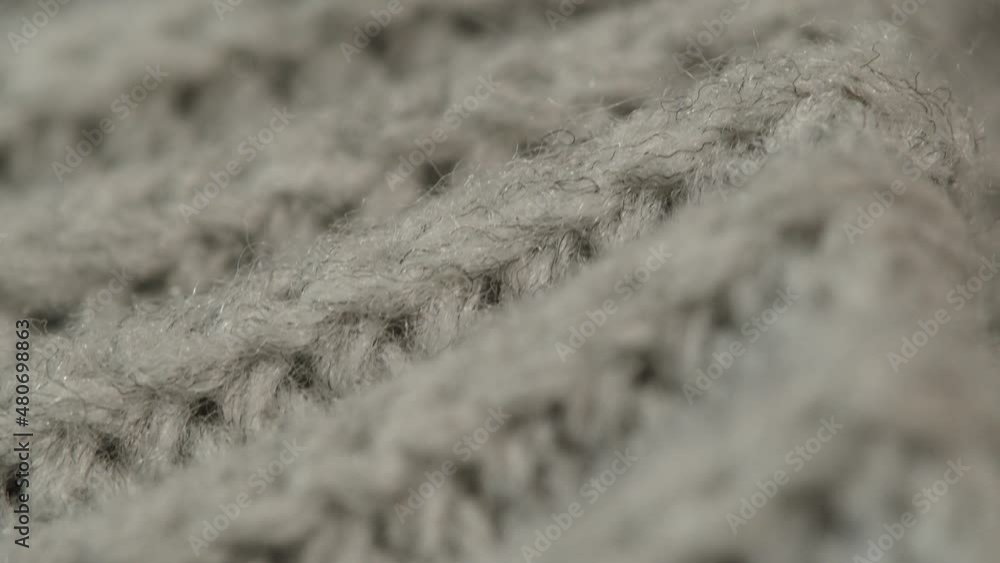 Grey knitted cloth, light gray woolen clothes fabric close-up, woven textile background. Grey knitted cloth, light gray woolen clothes fabric close-up, woven textile background.