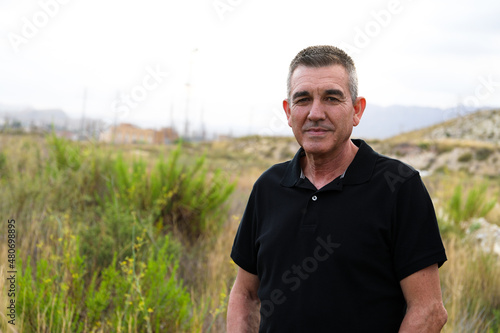 Handsome and healthy man who takes care of himself is 60 years old, in a field in Alicante
