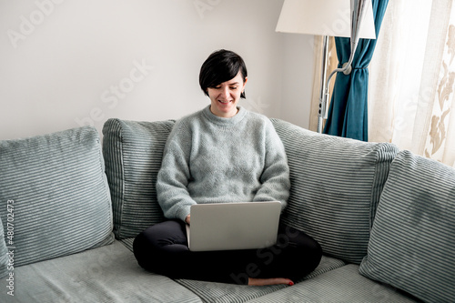 Young woman is resting on a sofa