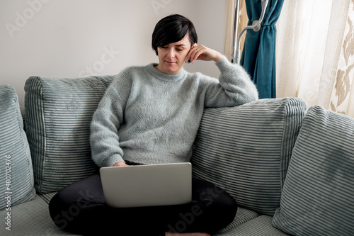 Young woman is resting on a sofa