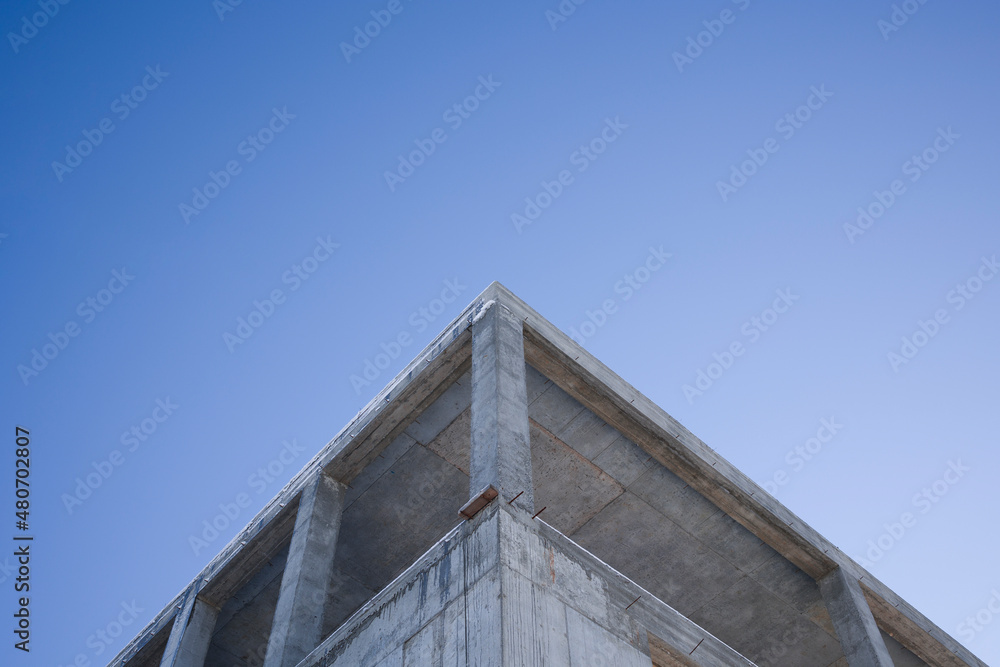 Low Angle View Of Unfinished Building Against Clear Blue Sky Low Angle View Of Unfinished Building Against Clear Blue Sky