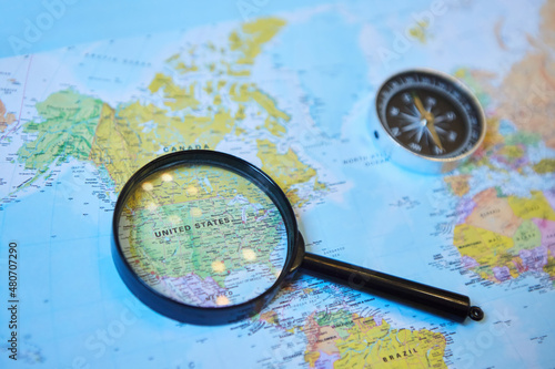 Obraz na plátně The magnifying glass is located on the world map and magnifies the country of USA