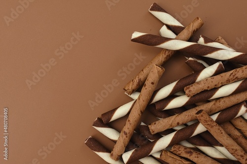 Chocolate wafers rolls on brown background
