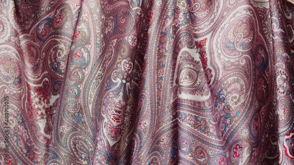 Pink silk fabric close-up, arabian design or indian pattern. Cloth texture background. Macro shooting of textile. Pink silk fabric close-up, arabian design or indian pattern. Cloth texture background. Macro shooting of textile.