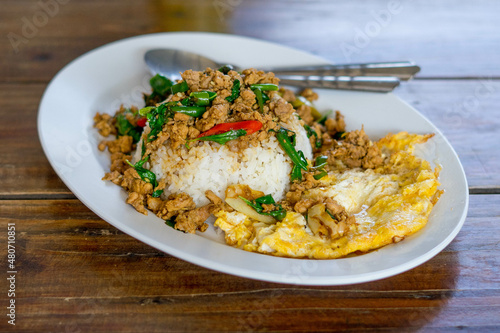 Rice topped with stir-fried pork 
and basil.Thai street food.Stir fried basil.