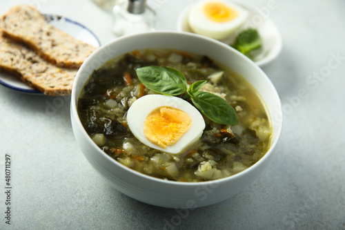 Traditional homemade green soup with hard boiled eggs 