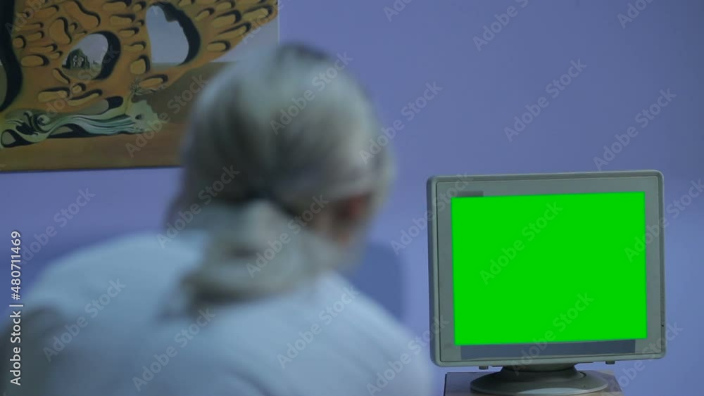 Doctor in operating room trying to help on intensive care patient, use defibrillator electrical device to shock heart. Looks at the monitor with vital data. Green Screen Doctor in operating room trying to help on intensive care patient, use defibrillator electrical device to shock heart. Looks at the monitor with vital data. Green Screen