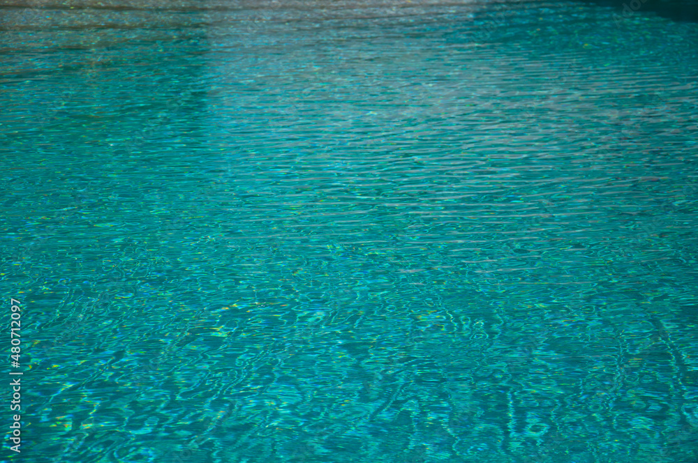 Wave pattern. Close-up of the water surface of the pool close up. Crystal texture