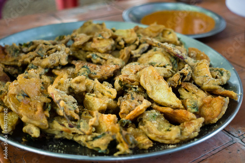 A tabletop shot of tea and pakodas on a road side stall in India. Most famous go to food in India.