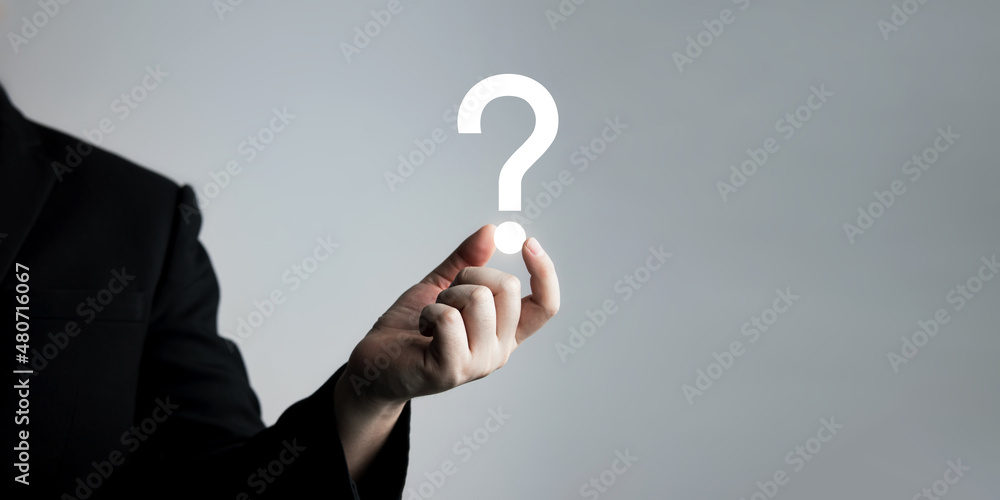businessman holding question mark. concept of Question mark and FAQs, Ask quiestion online, FAQ concept, what how and why, search information on internet.  - obrazy, fototapety, plakaty 