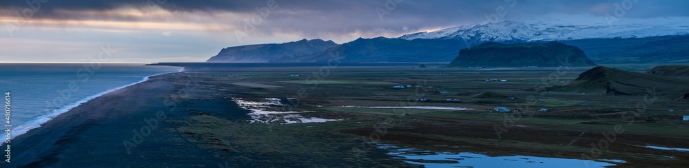 Picturesque autumn evening view to endless ocean black volcanic sand beach from Dyrholaey Cape Viewpoint, Vik, South Iceland. Picturesque autumn evening view to endless ocean black volcanic sand beach from Dyrholaey Cape Viewpoint, Vik, South Iceland.