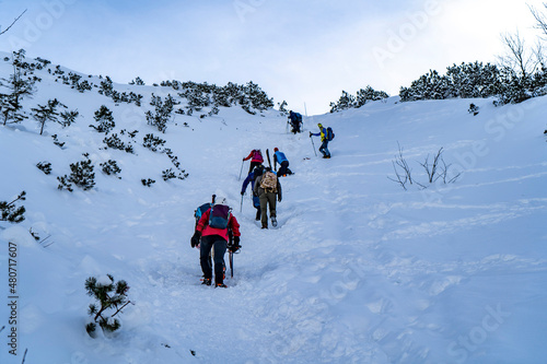 Fototapeta Naklejka Na Ścianę i Meble -  Tatra Mountains, Winter mountain landscape in the Tatras, tourists climb the snowy slopes, views of the snow-capped mountains in frosty sunny weather Poland