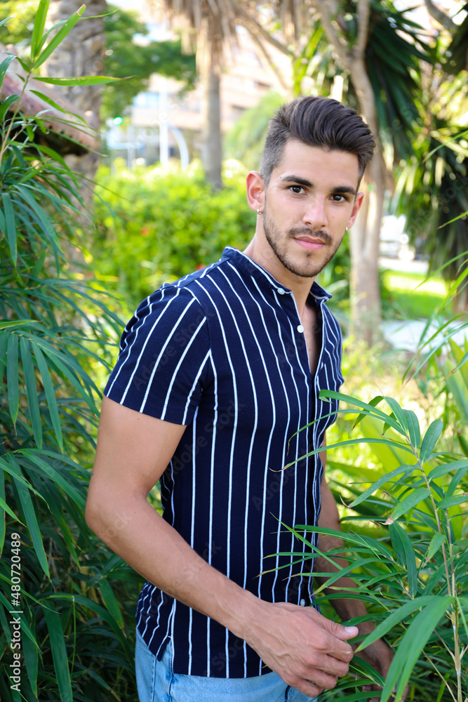 handsome dark-haired guy with a beard posing as a model in the city of Alicante in with him car handsome dark-haired guy with a beard posing as a model in the city of Alicante in with him car