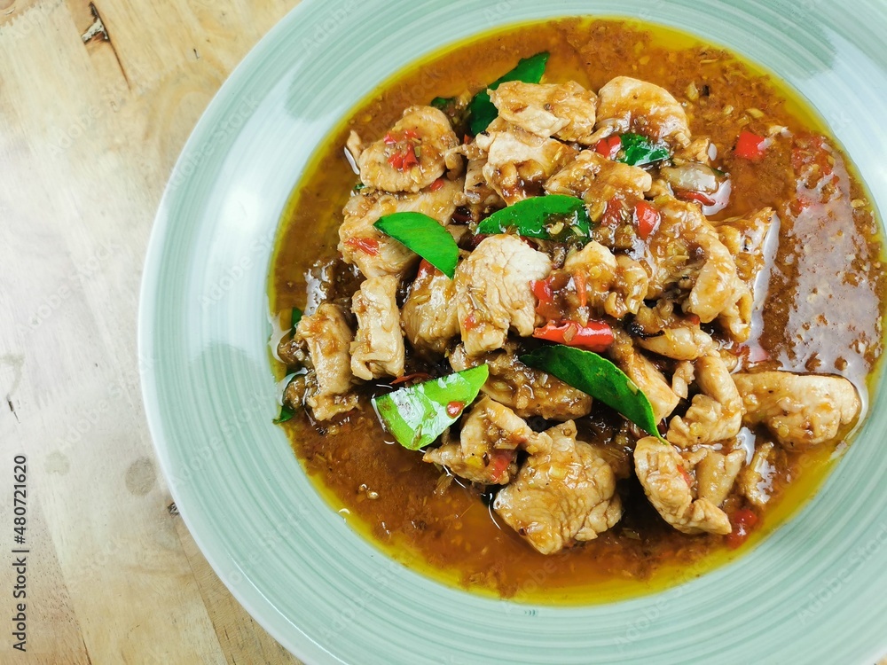 Fried chicken with lemongrass in a plate, ready to serve Fried chicken with lemongrass in a plate, ready to serve