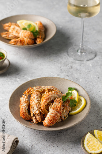 Wallpaper Mural Grilled shrimp with lemon and herbs butter sauce. Spiked shrimp-bear on a plate with a glass of white wine. Bering shrimp. Menu concept for restaurants Torontodigital.ca