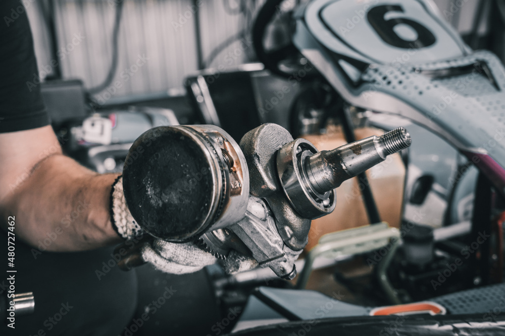 The mechanic go kart racing service pours fuel into the tank The mechanic go kart racing service pours fuel into the tank