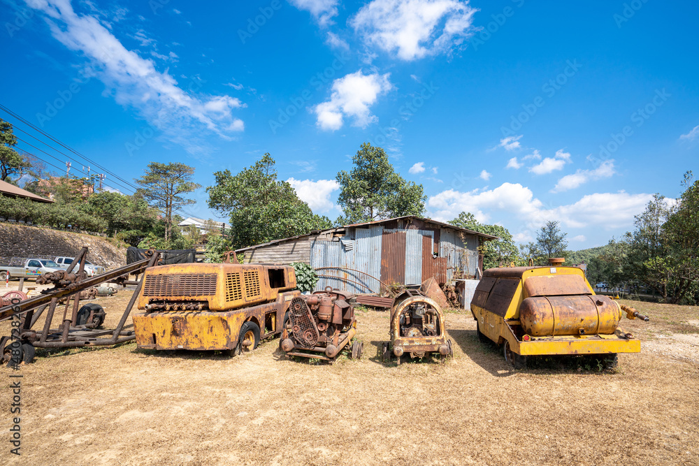 Fototapeta premium Kanchanaburi Thailand-Jan 16,2022 : Pilok Old mines and old machines laid out on the ground after the mine was closed for tourists,Landmark of Tourist in Thong Pha Phum District Kanchanaburi Thailand