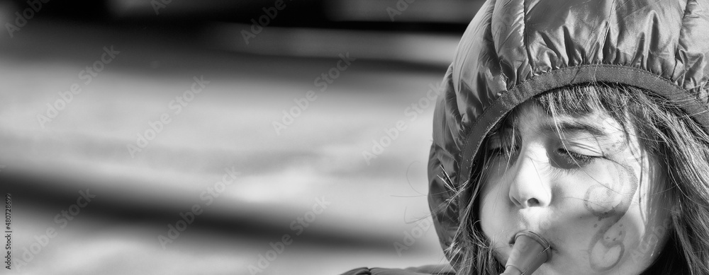 Happy young girl playing the flute in New Orleans for Mardi Gras carnival event.