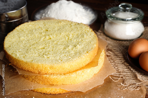 Photographie Homemade round sponge cake or chiffon cake on table so soft and delicious with ingredients: eggs, flour, milk on wood table