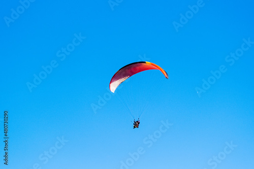 Parachutist on the background of blue sky