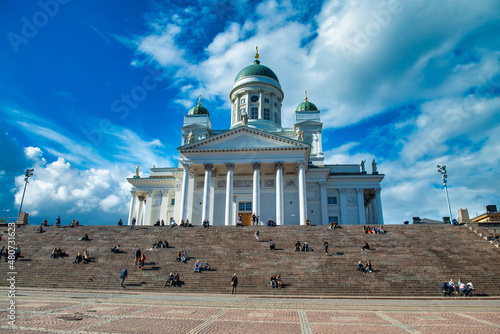 HELSINKI, FINLAND - JULY 4TH, 2017: Tourists visit Helsinki White Cathedral on a sunny day. photo