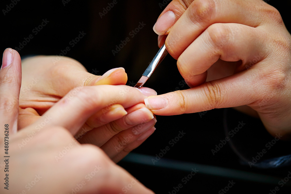 Nail art, close-up of hands trimming nails Nail art, close-up of hands trimming nails