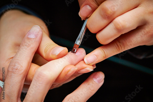 Nail art, close-up of hands trimming nails