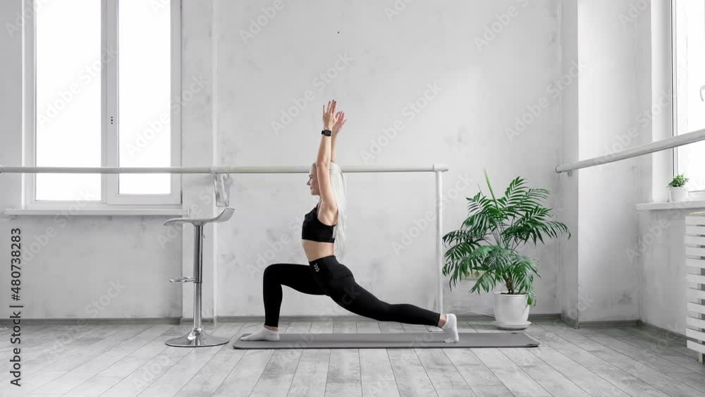 Blonde woman making fitness exercises on mat. Sporty female stretching in fitness studio. Training and making physical exercises for body indoors. Blonde woman making fitness exercises on mat. Sporty female stretching in fitness studio. Training and making physical exercises for body indoors.