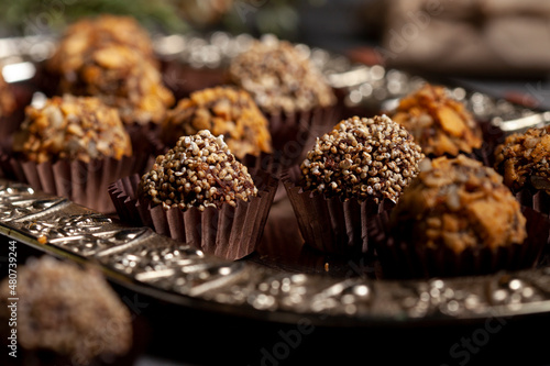 Various homemade raw vegan truffles or energy balls such as almonds and cocoa, dark chocolate and hazelnut butter
