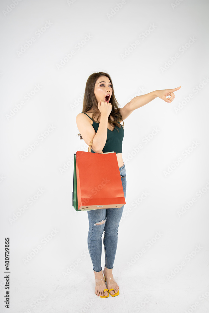 Woman holding paper bags with shock. Woman holding paper bags with shock.