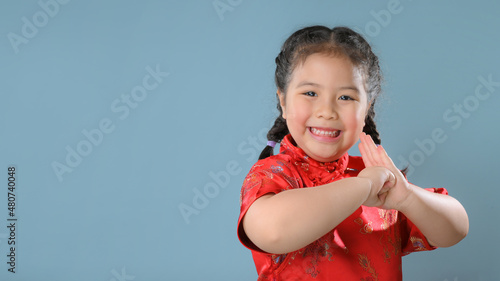 Smiling little asian child girls in red chinese traditional dress.Happy Chinese new year concept.